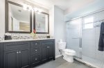 The en-suite bathroom features dual sinks and a walk in shower